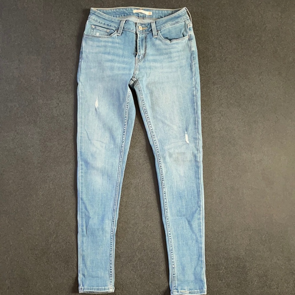 Levi’s 535 skinny jeans. Light wash will minor distressing.